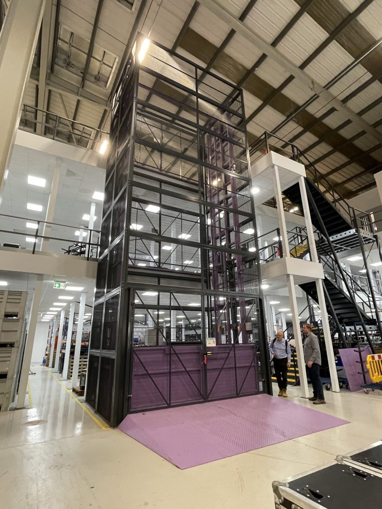Large goods lift installed in a warehouse with a ramp